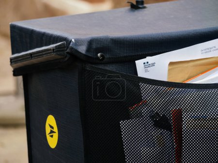 Photo for Haguenau, France - Mar 20, 2024: A close-up view of a French postal service bike box, with visible envelopes and the La Poste logo, ready for mail delivery and Republique Francaise from the goverment - Royalty Free Image