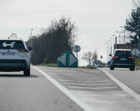 Photo for Haguenau, France - Mar 20, 2024: Cars including a silver Toyota RAV4 traveling on a highway near Haguenau, France, under clear skies - Royalty Free Image