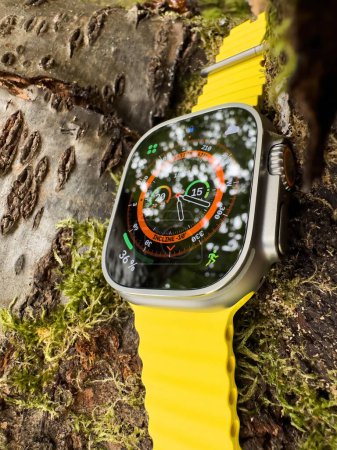 Photo for London, United Kingdom - Sep 23, 2022: Positioned on a cherry tree branch, the new Apple Watch Ultra shows the time at 17:20, blending technology with nature - Royalty Free Image