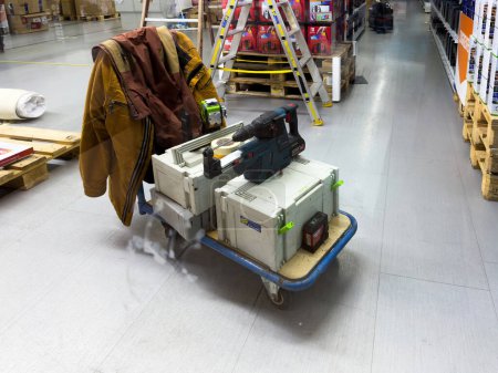 Photo for Freiburg im Breisgau, Germany - Mar 7, 2024: Bosch drill and Festool systainers placed on a cart in a supermarket, used for store premises repairs. - Royalty Free Image
