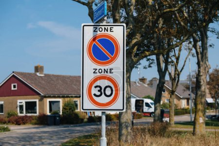 Speed limit and no parking sign in a residential area in Texel, Netherlands on the Elmert street