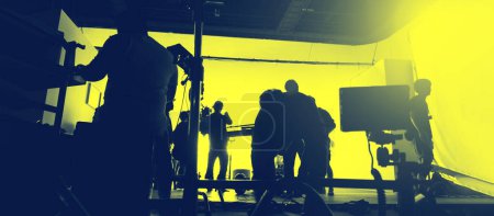 Photo for Behind the scenes of shooting video production and lighting set for filming movie which film crew team working in silhouette and professional equipment in studio for video online. video production - Royalty Free Image