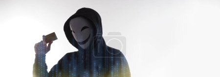 Photo for Hacker man and credit cards in hand. Represent credit cards personal data stolen by anonymous man in Black hood shirt. Credit cards data security and Cyber crime digital. Money transection unsecured. - Royalty Free Image