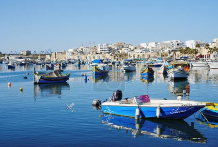 Photo for MARSAXLOKK, MALTA on May 2022: Fishing boats in port of european town, clear blue sky in warm sunny spring day. - Royalty Free Image
