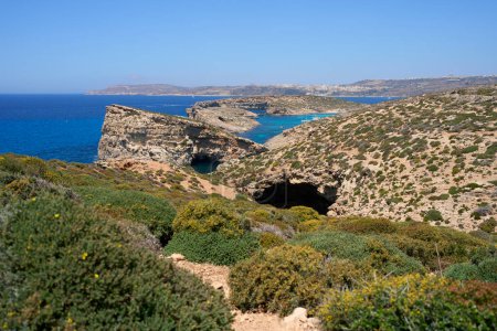 Exotic blue lagoon at european Comino island in Malta, clear blue sky in 2022 warm sunny spring day on May.