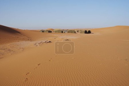 Photo for Berber camp at Erg Chigaga dunes on Sahara desert in african southeastern MOROCCO, clear blue sky in 2023 warm sunny winter day on January. - Royalty Free Image