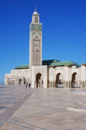 Foto de La mezquita Hassan II con minarete en la ciudad africana de Casablanca en Marruecos, cielo azul claro en 2023 cálido día de invierno soleado en enero - vertical - Imagen libre de derechos