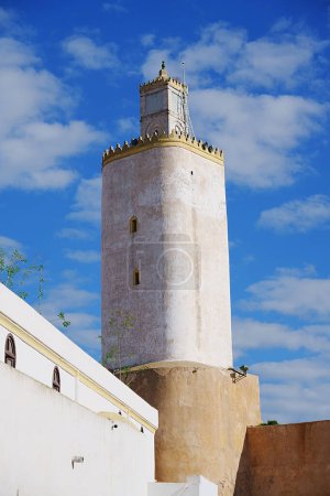 Photo for Minaret and former Portugese lighthouse in african MAZAGAN city in Morocco, clear blue sky in 2023 warm sunny winter day on January - vertical - Royalty Free Image