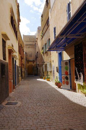 Photo for Old alley in african MAZAGAN city in Morocco, clear blue sky in 2023 warm sunny winter day on January - vertical - Royalty Free Image
