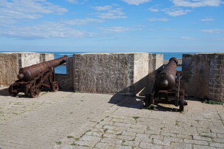 Photo for Two cannons at ramparts of african MAZAGAN city in Morocco, clear blue sky in 2023 warm sunny winter day on January. - Royalty Free Image