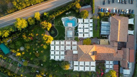 Photo for Drone photo of wedding party outdoors in Italian villa at sunset - Royalty Free Image