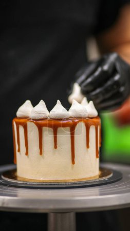 Photo for Cake designer at work with a cupcake - Royalty Free Image
