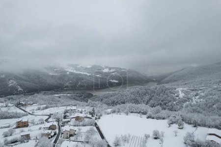 Photo for Aerial shot of winter landscape near italian apennines town covered in snow in a little town called Castelletto, Verncasca Italy - Royalty Free Image
