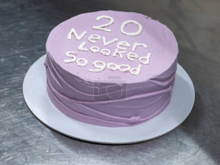 Photo for 20 years old frosted cake decorated with a cream handmade phrase by baker designer - Royalty Free Image
