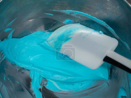 Foto de Turquoise icing piping filling for frosted cake decoration in kitchen lab - Imagen libre de derechos