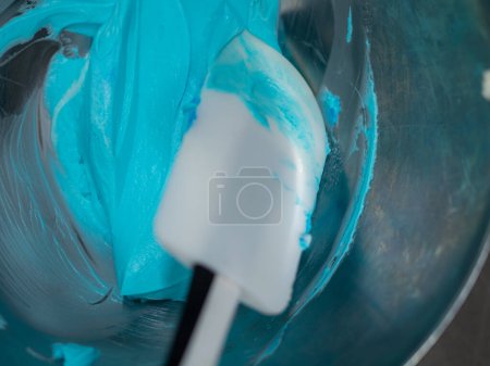 Photo for Turquoise icing piping filling for frosted cake decoration in kitchen lab - Royalty Free Image