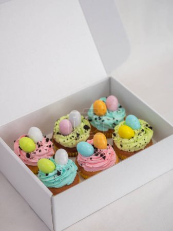 Photo for Easter pastel handmade group of muffins with confetti chocolate eggs on top - Royalty Free Image