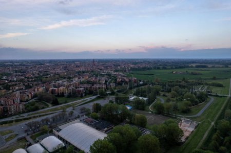 Photo for Aerial drone shot of Cremona and the river Po at sunset, the bridge, the orange sky, Lombardy, Italy - Royalty Free Image