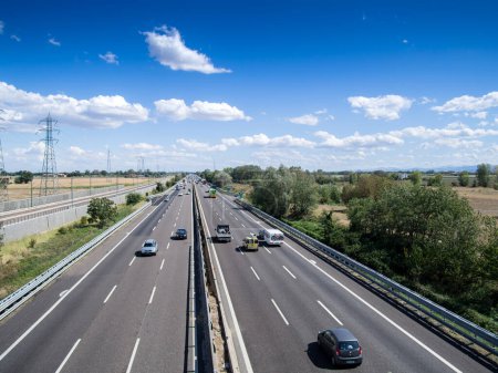 Photo for Piacenza, Italy - September 2017 cars and truck on motorway a1 autostrada del sole , daylight, serene sky with clouds. - Royalty Free Image