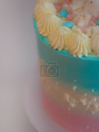 Photo for Preparing frosted pink blue cup cake with meringue, sweet sprinkles and unicorn topping - Royalty Free Image
