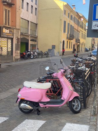 Photo for Cremona, Italy - May 2023 pink Vespa motorbike parked on the streets of city - Royalty Free Image