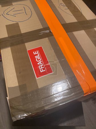 a cardboard box ready for shipping with fragile tag on it , packaging concept high res image