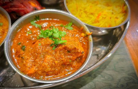Téléchargez les photos : Cuisine indienne traditionnelle. Assortiment de nourriture indienne sur la table dans le restaurant. apéritifs et plats de la cuisine indienne. Curry, riz, samosa, naan, poulet au beurre, chutney, épices, Palak Paneer, Tikka, Roti - en image libre de droit