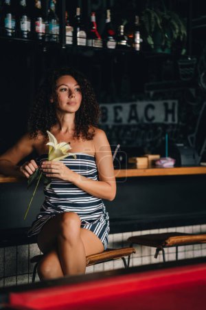 Photo for Portrait of a curly woman sitting in a bar. High quality photo - Royalty Free Image