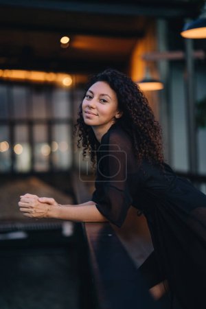 Photo for Portrait of a curly woman at dark background with lights. High quality photo - Royalty Free Image
