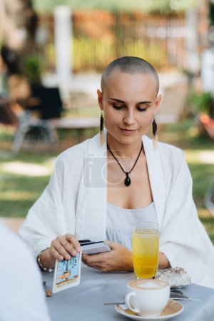 Photo for A bald woman tarot reader has a session with a client. High quality photo - Royalty Free Image