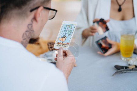 Photo for A customer looking at a tarot card. High quality photo - Royalty Free Image