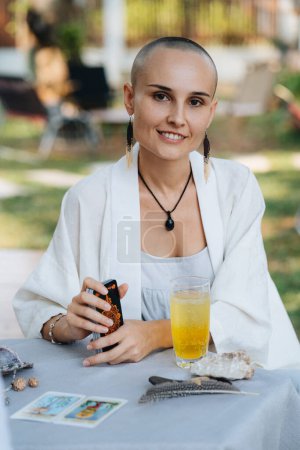 Photo for A portrait of a bald woman tarot reader in a outdoor cafe - Royalty Free Image