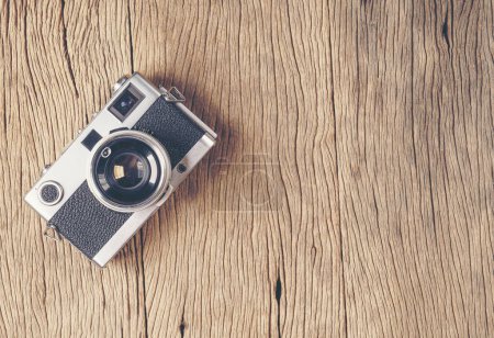 Photo for Vintage old film camera on wood board with copy space - Royalty Free Image