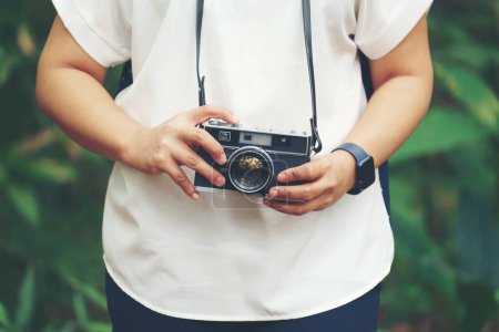 Photo for Woman with vintage camera in park - Royalty Free Image