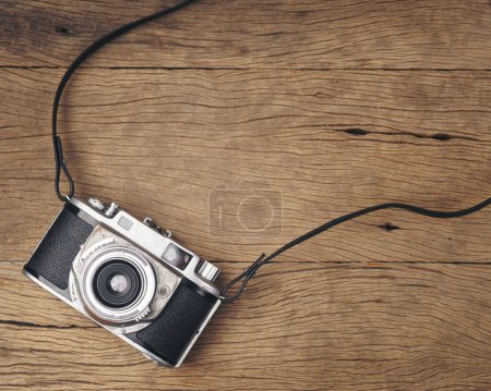Photo for Vintage old film camera on wood board with copy space - Royalty Free Image