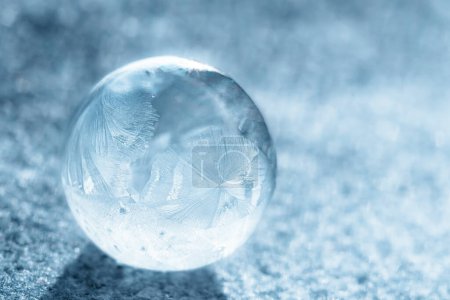 Photo for Frozen bubble with bokeh background. Beautiful frosty patterns on frozen soap bubble. winter, frosty background. Macro photo - Royalty Free Image