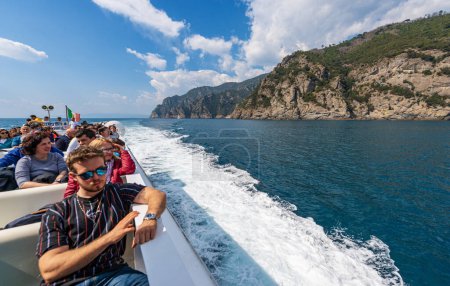 Photo for PORTOFINO, ITALY - APR 8, 2023: Ferry with tourists in motion from San Fruttuoso to Portofino, tourist resorts in Genoa Province, Liguria, Italy, Europe. Rocky coastline and Mediterranean sea. - Royalty Free Image