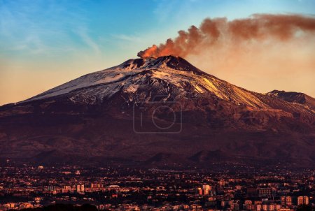 Catania cityscape and the Mount Etna Volcano with smoke at dawn, Sicily island, Italy, Europe