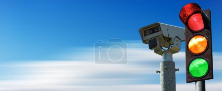 Photo for Closeup of a traffic light and a traffic control camera against a clear blue sky in motion with copy space. - Royalty Free Image