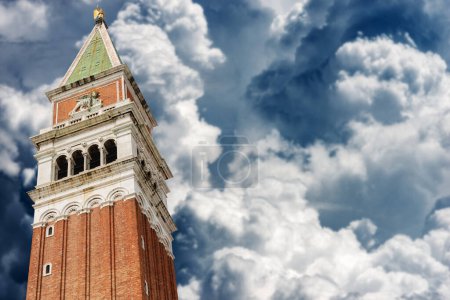 Photo for Venice, Campanile di San Marco (bell tower) in St. Mark square, against a sky with beautiful cumulus clouds. UNESCO world heritage site, Veneto, Italy, Europe. - Royalty Free Image