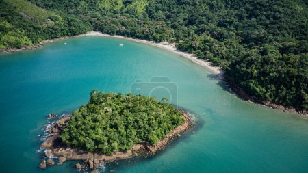 Photo for Beach landscape on a sunny day, seen from above, drone photography, calm turquoise waters, with a small island in the foreground, mountains with forest, Praia da Justa, Ubatuba - Sao Paulo - Brasil - Royalty Free Image