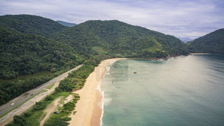 Photo for Vermelha do Norte Beach in Ubatuba - SP - with calm waters, known for surfing, nature on a cloudy day, tropical forest, landscape and drone photography, with aerial view in high resolution - Royalty Free Image