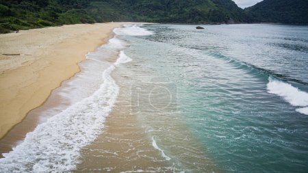 Photo for Vermelha do Norte Beach in Ubatuba - SP - with calm waters, known for surfing, nature on a cloudy day, tropical forest, landscape and drone photography, with aerial view in high resolution - Royalty Free Image