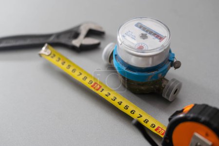 Photo for Water meter on a light background. Figures for measuring water in cubic meters. Round shape of the case - Royalty Free Image