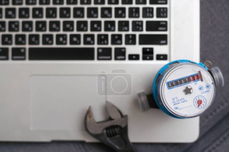 Photo for Close up shot water meter and laptop. - Royalty Free Image