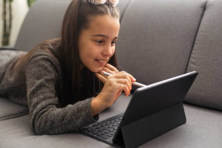 Photo for Close up of girls hands typing on tablet at homework session - Royalty Free Image