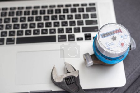 Photo for Close up shot water meter and laptop. - Royalty Free Image