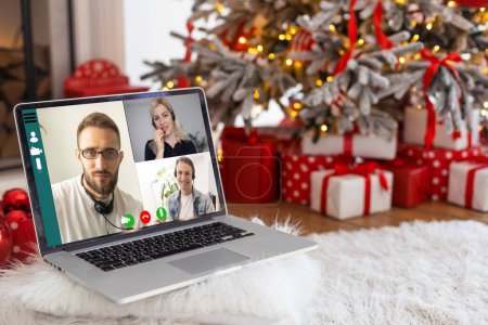 Photo for People on virtual call with family and friends exchanging gifts and celebrating virtual christmas online due to social distancing and coronavirus lockdown and quarantines. Image on computer screen - Royalty Free Image
