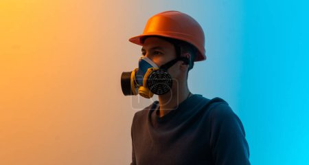 Photo for A man in a mask with a filter and a helmet color background. - Royalty Free Image