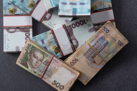 Foto de Bundles of Ukrainian money, stacks of hryvnia, 200,500,1000 money concept. Lots of banknotes. Side view. - Imagen libre de derechos